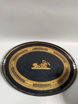 two black and gold trays sitting on top of a white table
