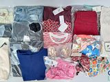 many different types of clothes and bags on the table