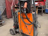 a welding machine that is sitting in a garage