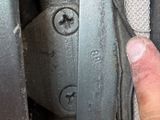 a hand that is pointing at a piece of metal