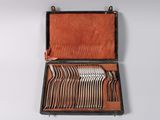 an old suitcase with a bunch of forks and spoons in it