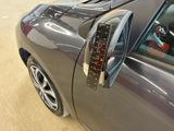 a close up of a car ' s door handle with a clock on it