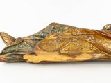 a statue of a woman laying down on the ground