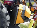 a tractor that is parked next to a pile of tires