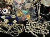 a lot of beads and necklaces that are on a table