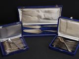 three pieces of silverware in a blue case on a black surface