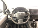 the interior of a car with a steering wheel and dashboard controls