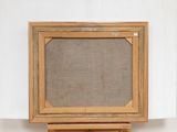 an old wooden easel with a canvas on top of it