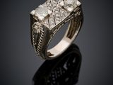 a close up of a gold ring with diamonds on a black surface