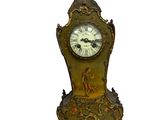 a clock that is sitting on a stand on a white background