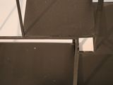 a close up of a metal shelf with a mirror on top of it