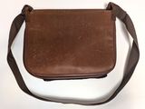 brown leather messenger bag on white background with strap