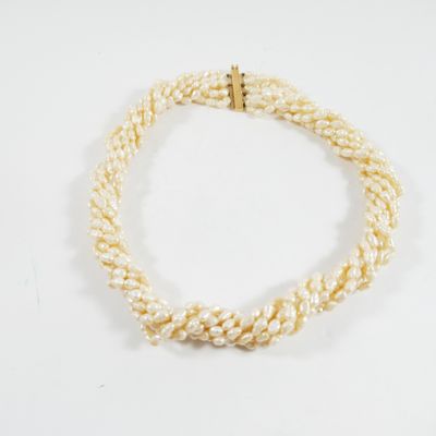 gros plan d'un collier de perles blanches sur une surface blanche