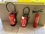 three fire extinguisors sitting on the floor next to each other
