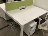 a white desk with a chair and a computer on it