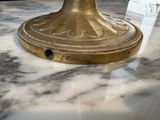 a gold plated lamp on a marble counter top