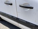 a white van with black trims parked in a parking lot