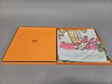 an orange box containing a handkerchief with a picture of a dragon on it