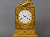 a gold clock with a statue of a lion on top of it