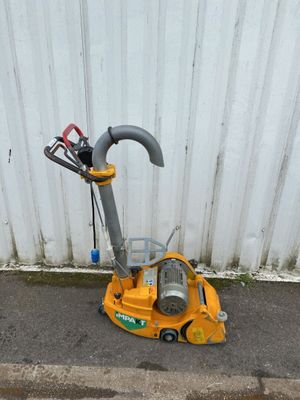 a yellow machine that is sitting on the ground
