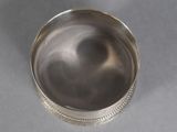 a close up of a silver container on a gray surface