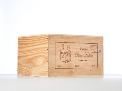 a wooden box with a label on it sitting on a table