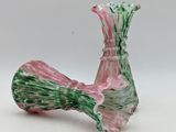 a glass vase with a green and pink design on it