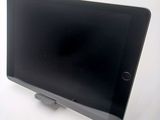 a tablet that is sitting on a stand on a table