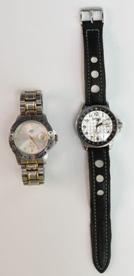 two watches sitting next to each other on a table
