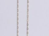 a silver necklace with a gold clasp on a white background
