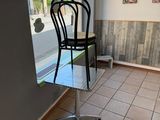a black chair sitting in front of a window in a restaurant