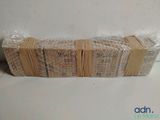 a stack of books wrapped in plastic wrap on a table