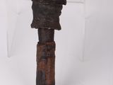 an old hammer with a wooden handle sitting on top of a white surface