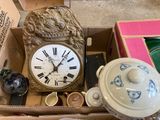 a box with a clock inside of it on the floor