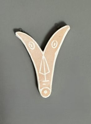an image of a wooden letter v with a face