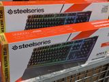 two boxes of steelseries keyboard on display in a store