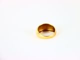 an image of a gold ring on a white surface