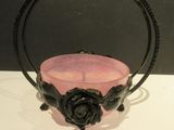 a pink glass bowl with a rose decoration on it