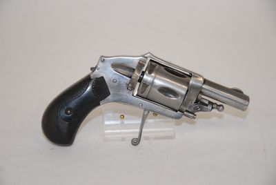 an old revolver with a black handle on a white surface