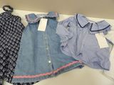 two dresses and a shirt are sitting on a table