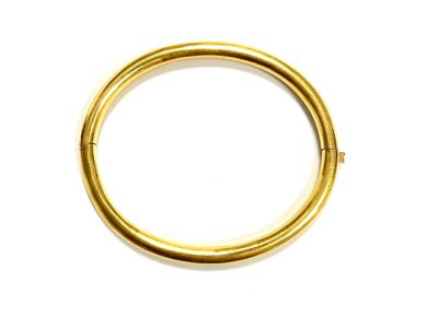 a close up of a gold ring on a white surface