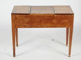 a small wooden table with two drawers on it