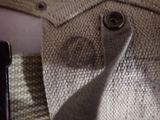 a close up of a person ' s shirt and tie with a cell phone next to it