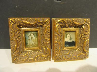 pair of antique gold picture frames of a man and a woman