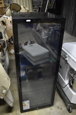 a refrigerator with a glass door in a garage