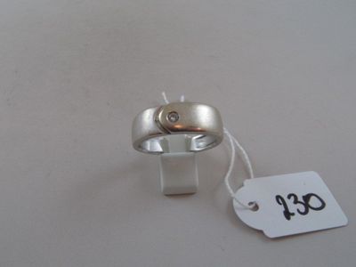 a silver ring with a diamond on it and a price tag attached to it