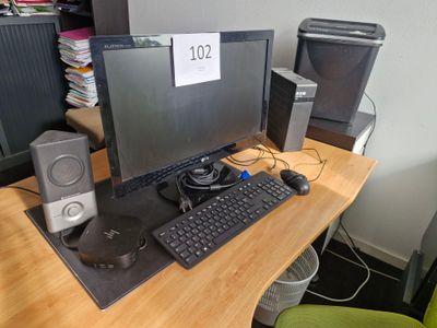 un bureau d'ordinateur équipé d'un écran, d'un clavier, de haut-parleurs et d'une souris