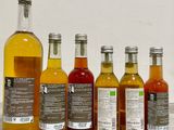 several bottles of different flavored beverages are lined up on a table