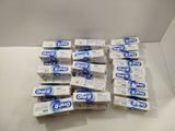 several boxes of toothpaste sitting on top of a white table