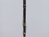 a close up of a black and gold pen on a clear stand